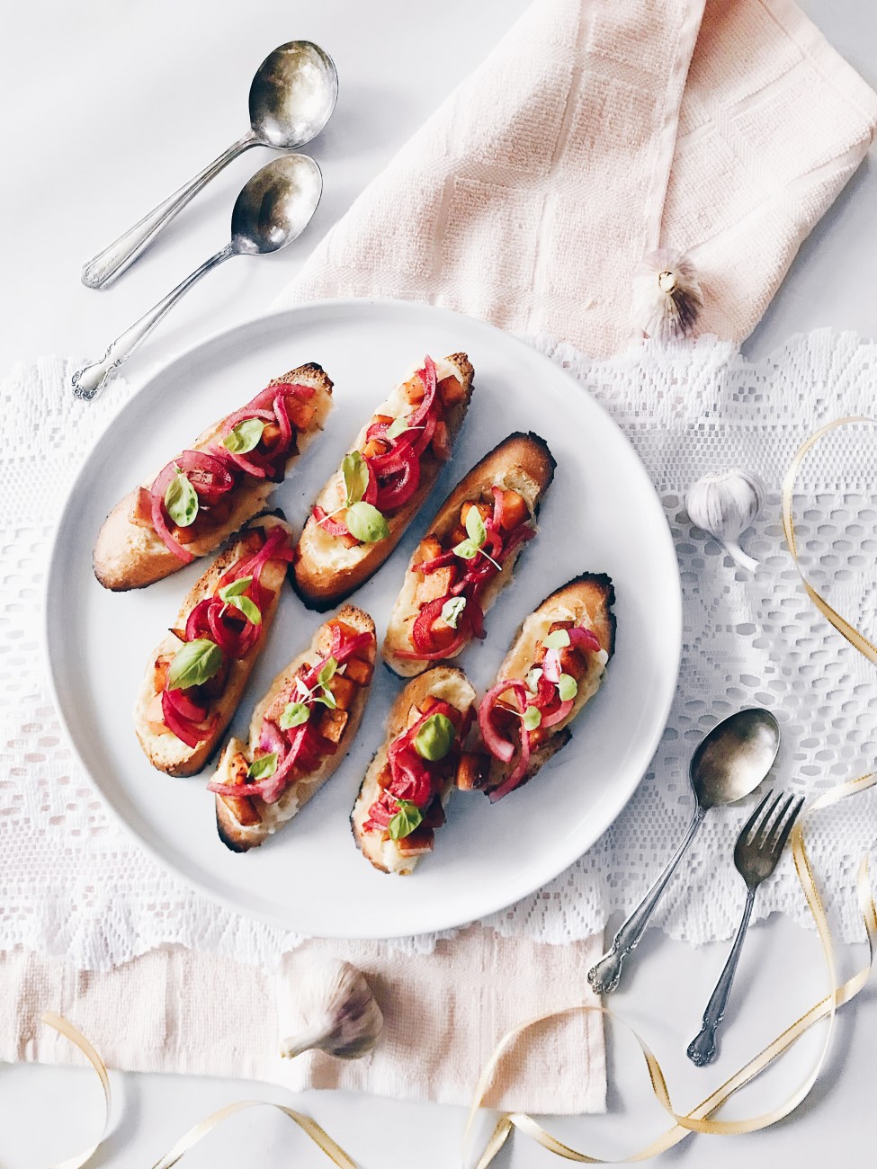 Crostinis aux patates douces, oignons rouges marinés et fromage